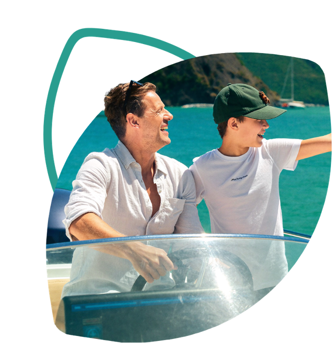 Pai e filho sorrindo a bordo de uma lancha em dia de sol, cliente Baru Náutico e Off-Road